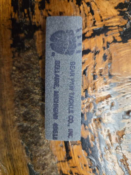 Printed Bear Paw Tackle Co. face of the gray rectangular sharpening stone