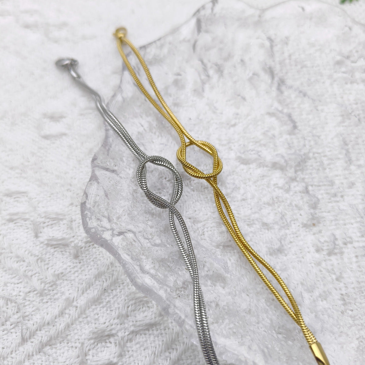 Actual gold and silver Willow & Wren double strand knot bracelets photographed together
