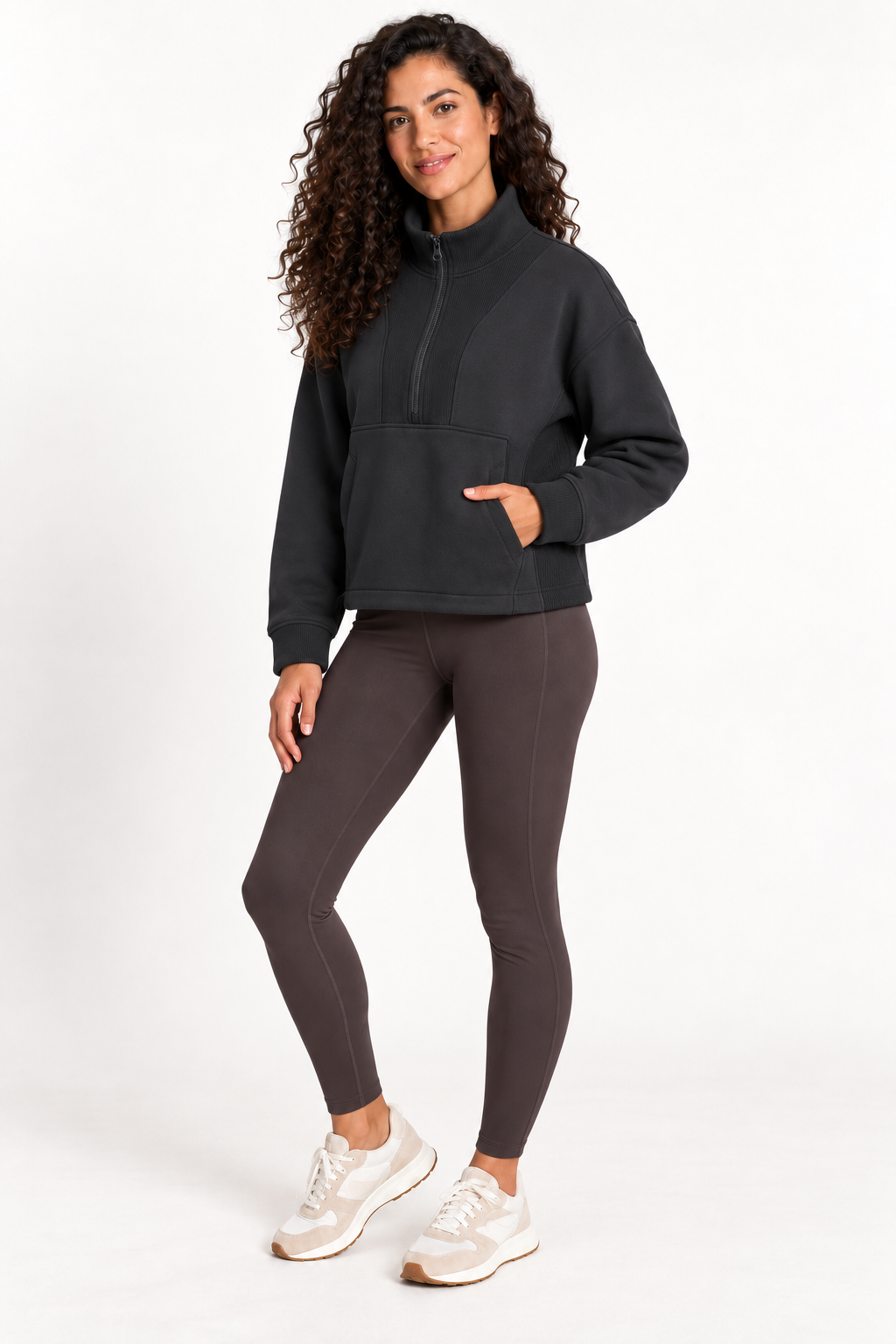 Three-quarter front view of a model wearing the Grace Fairhope Boxy Quarter Zip in Black