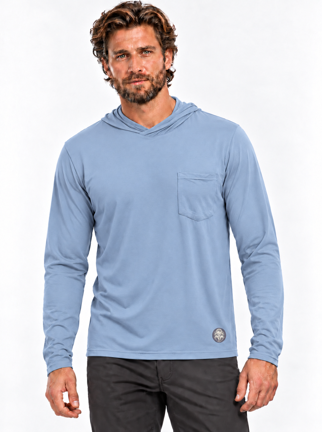 RBO model wearing the Coastal Blue Stealth Hoodie with chest pocket and Sasquatch face graphic at the lower hem