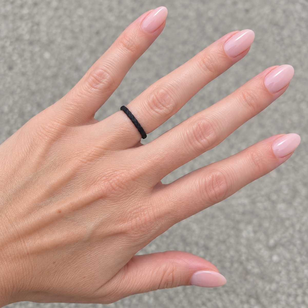 Titan Rings women’s braided black silicone ring on a feminine hand