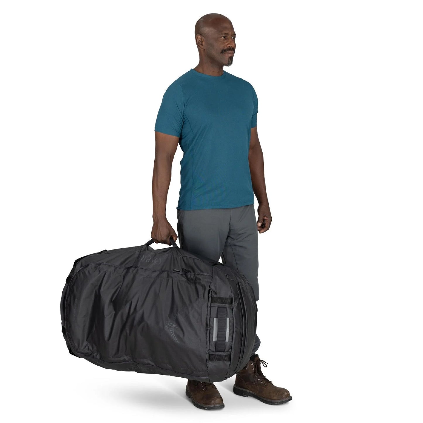 Man carrying the Osprey Transporter Duffel 150 by side handle for scale