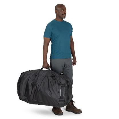 Man carrying the Osprey Transporter Duffel 150 by side handle for scale