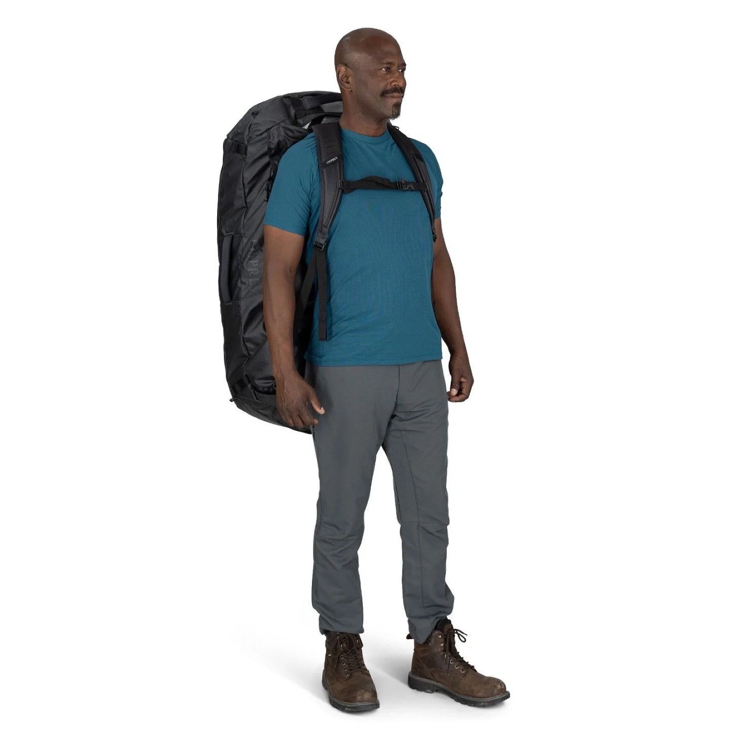 Man wearing the Osprey Transporter Duffel 150 as a backpack with padded harness straps
