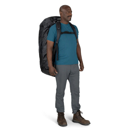 Man wearing the Osprey Transporter Duffel 150 as a backpack with padded harness straps
