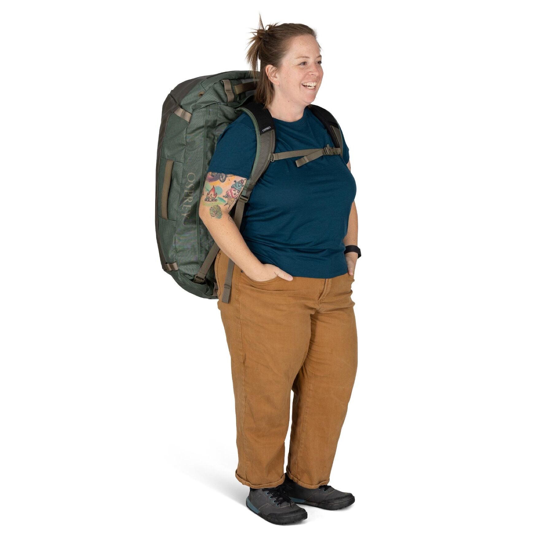 Osprey Transporter Duffel 95 in Pine Leaf Earl Grey carried on back by woman