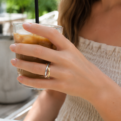 Woman wearing the Willow + Wren Everly Mixed Metal Interlocking Ring at an outdoor Gulf Coast café