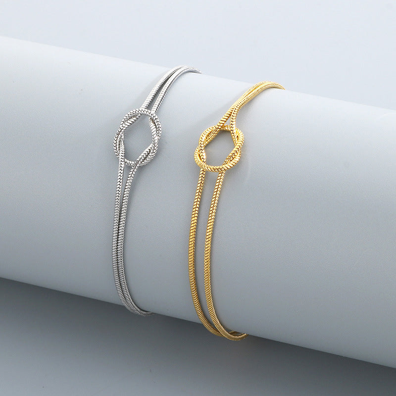 Actual Willow & Wren Double Strand Knot Bracelets in silver and gold on display