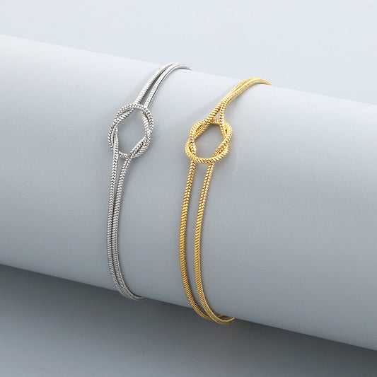 Actual Willow & Wren Double Strand Knot Bracelets in silver and gold on display