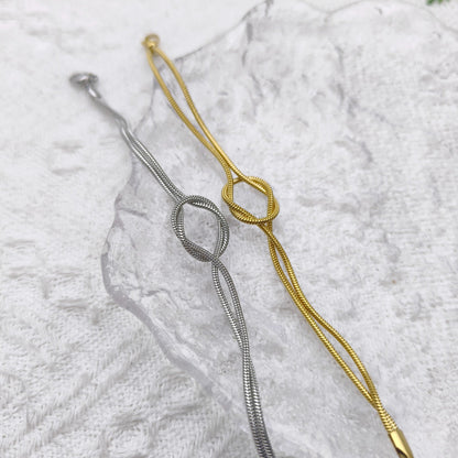 Actual gold and silver Willow & Wren double strand knot bracelets photographed together