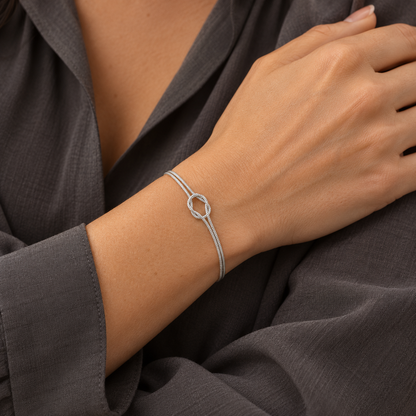 Silver Willow & Wren Double Strand Knot Bracelet shown on a woman's wrist, styled image